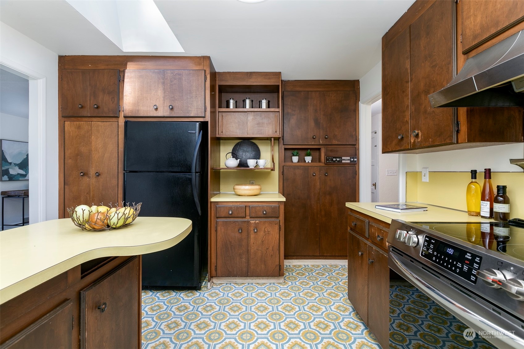3203 Northeast 88th Street Seattle, WA 98115 - Photo 7 of 28 a kitchen with stainless steel appliances granite countertop a sink and cabinets