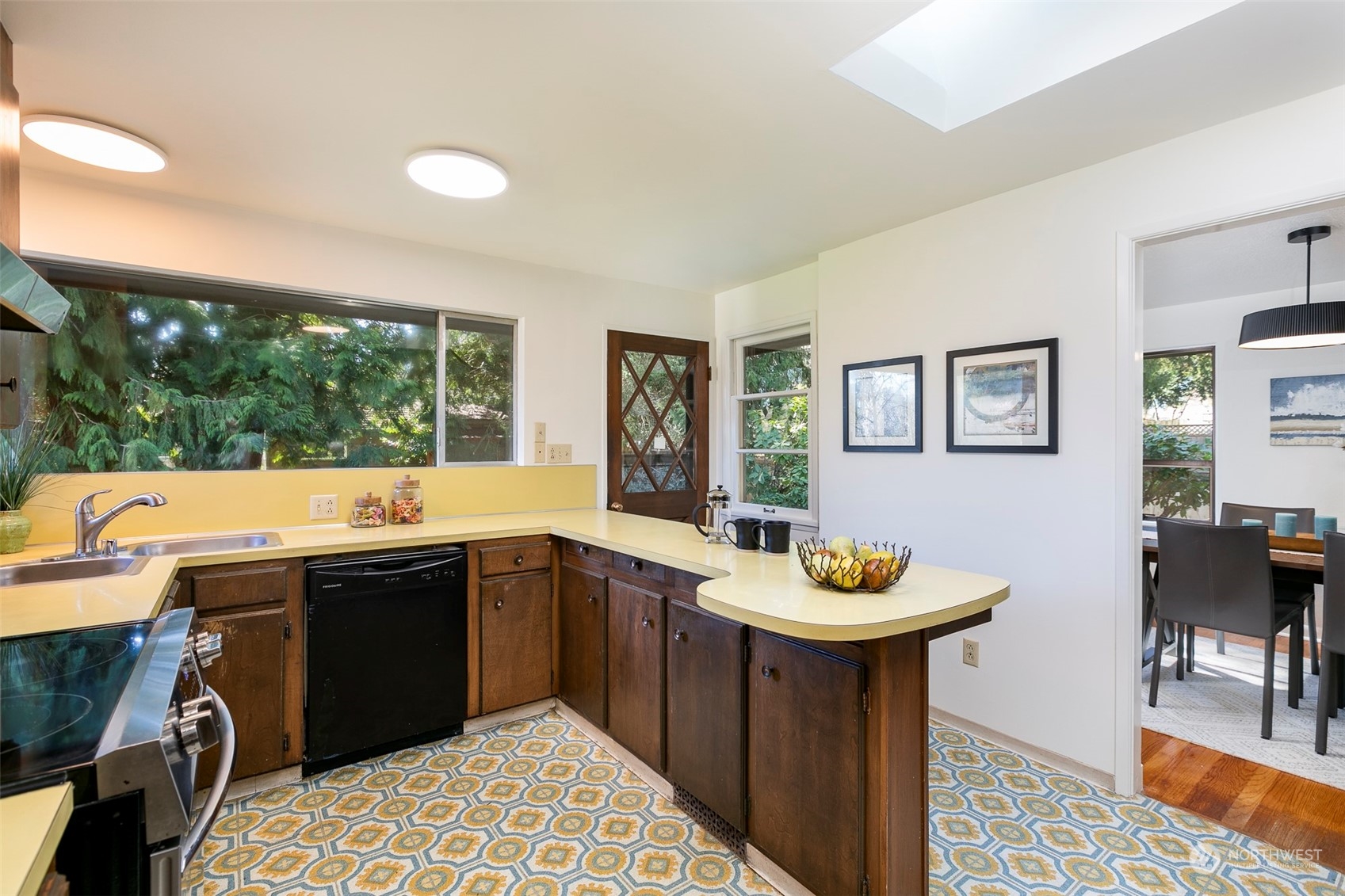 3203 Northeast 88th Street Seattle, WA 98115 - Photo 8 of 28 a kitchen with a sink and chairs