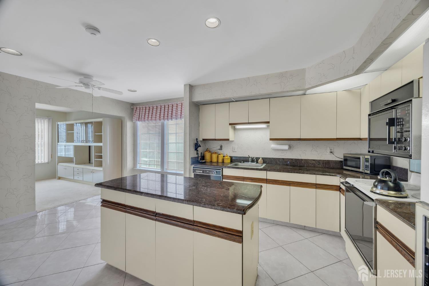6 Winslow Road Monroe Township, NJ 08831 - Photo 13 of 33 a kitchen with stainless steel appliances granite countertop a sink stove refrigerator and cabinets