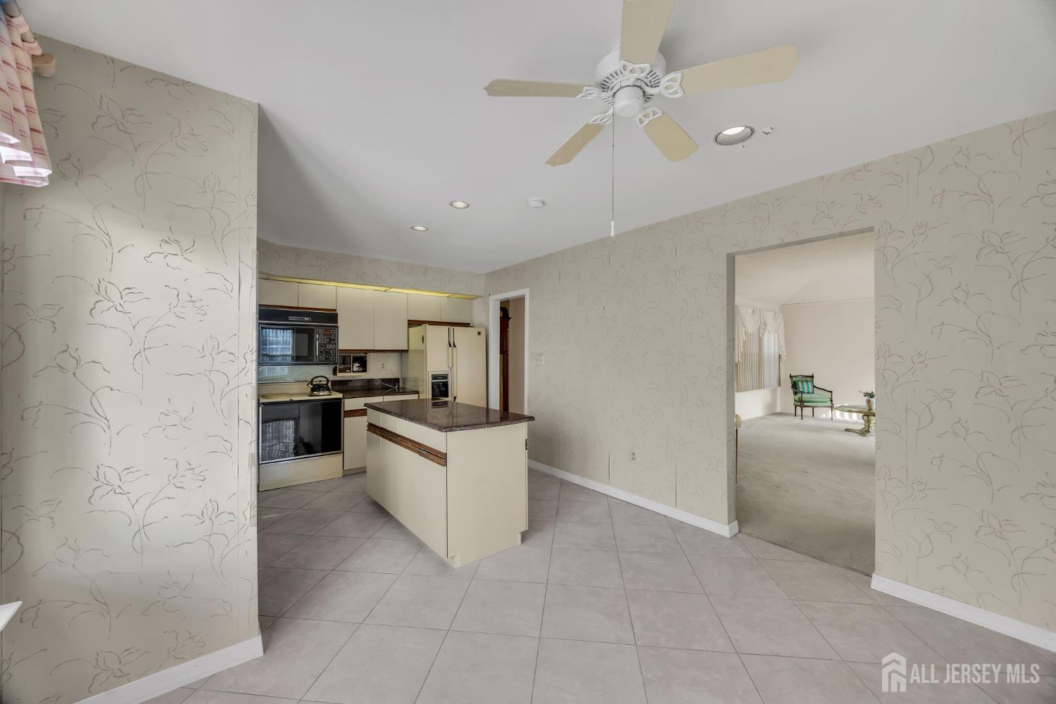 6 Winslow Road Monroe Township, NJ 08831 - Photo 15 of 33 a kitchen with cabinets and white appliances