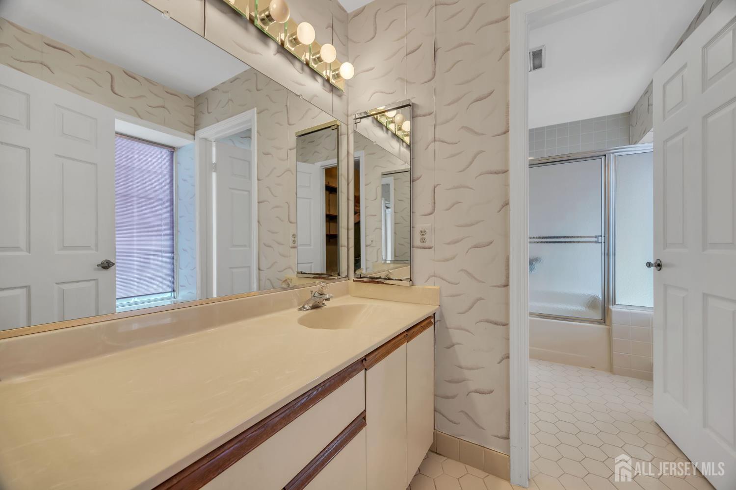 6 Winslow Road Monroe Township, NJ 08831 - Photo 28 of 33 a bathroom with a sink a vanity and a mirror