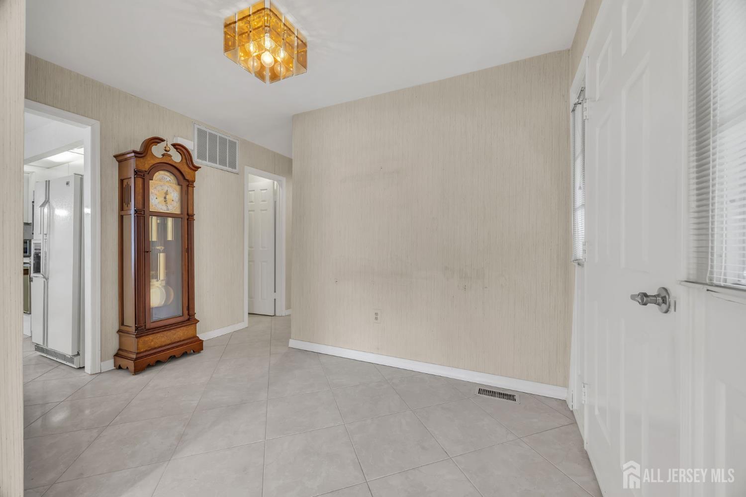 6 Winslow Road Monroe Township, NJ 08831 - Photo 4 of 33 an empty room with window and mirror