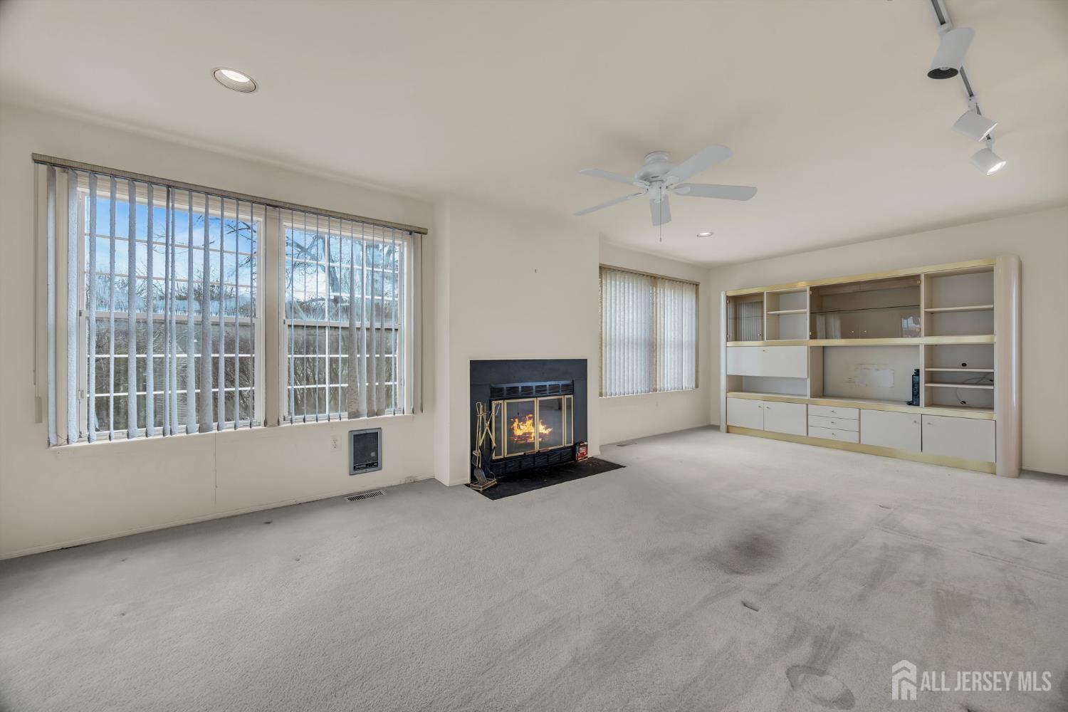 6 Winslow Road Monroe Township, NJ 08831 - Photo 10 of 33 a view of an empty room with a window and a fireplace