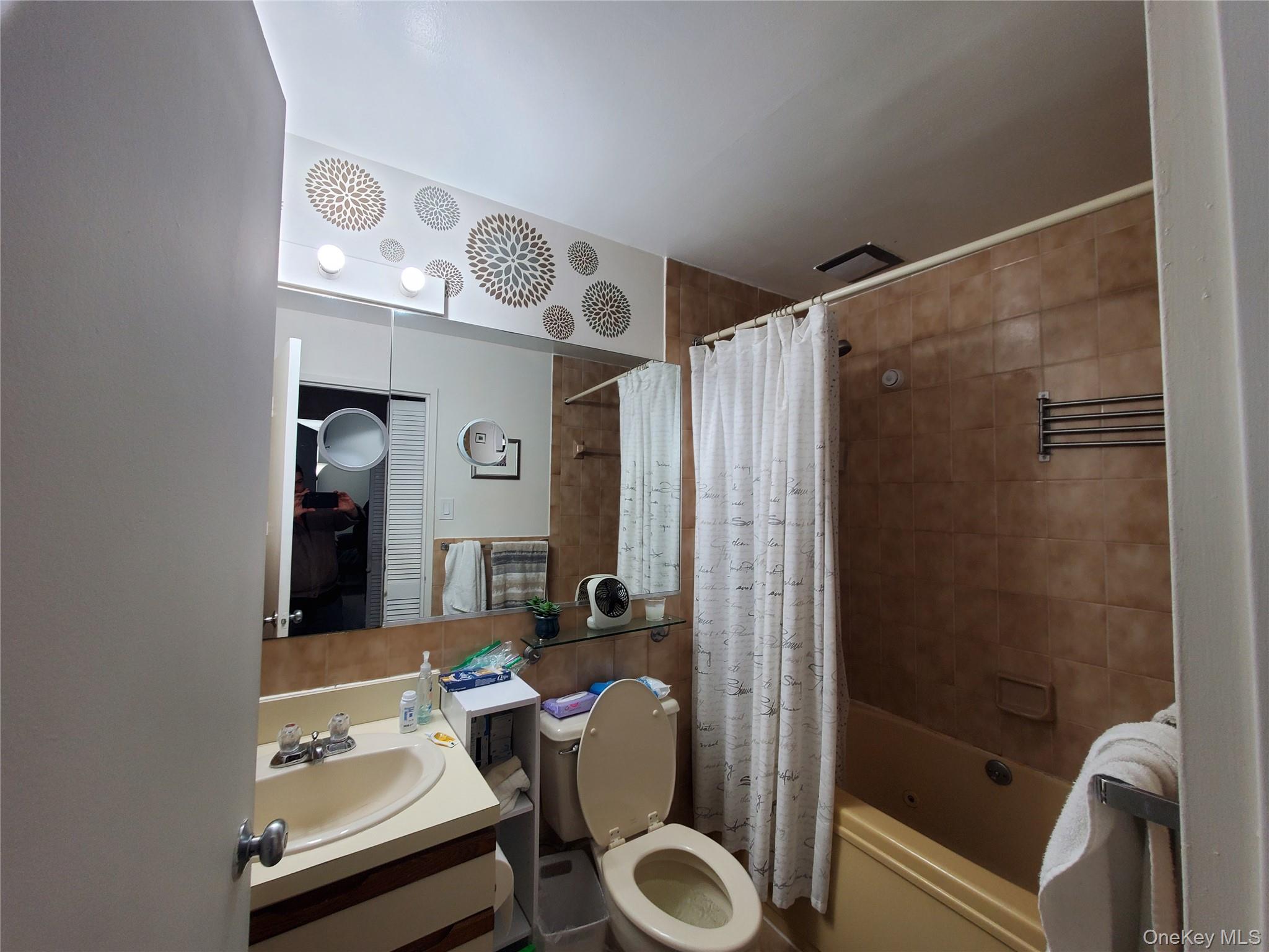 360 Shore Road, Unit 5A Long Beach, NY 11561 - Photo 10 of 16 a bathroom with a sink a toilet and shower