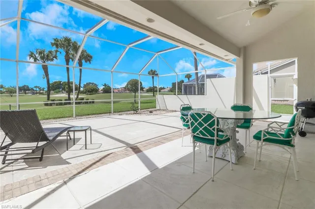 a view of a patio with a table and chairs