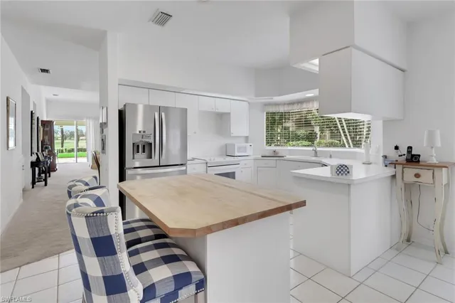 a kitchen with a sink a counter top space and stainless steel appliances