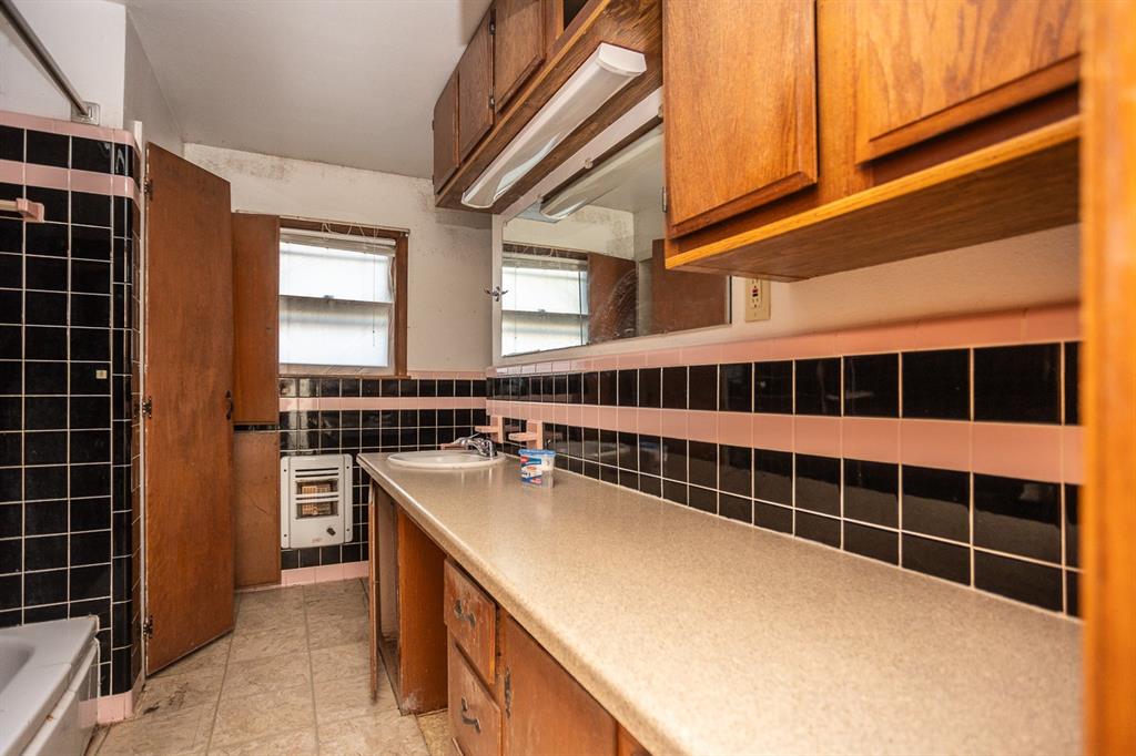 1414 Rice Avenue Gainesville, TX 76240 - Photo 9 of 21 a view of a kitchen with a sink and cabinets