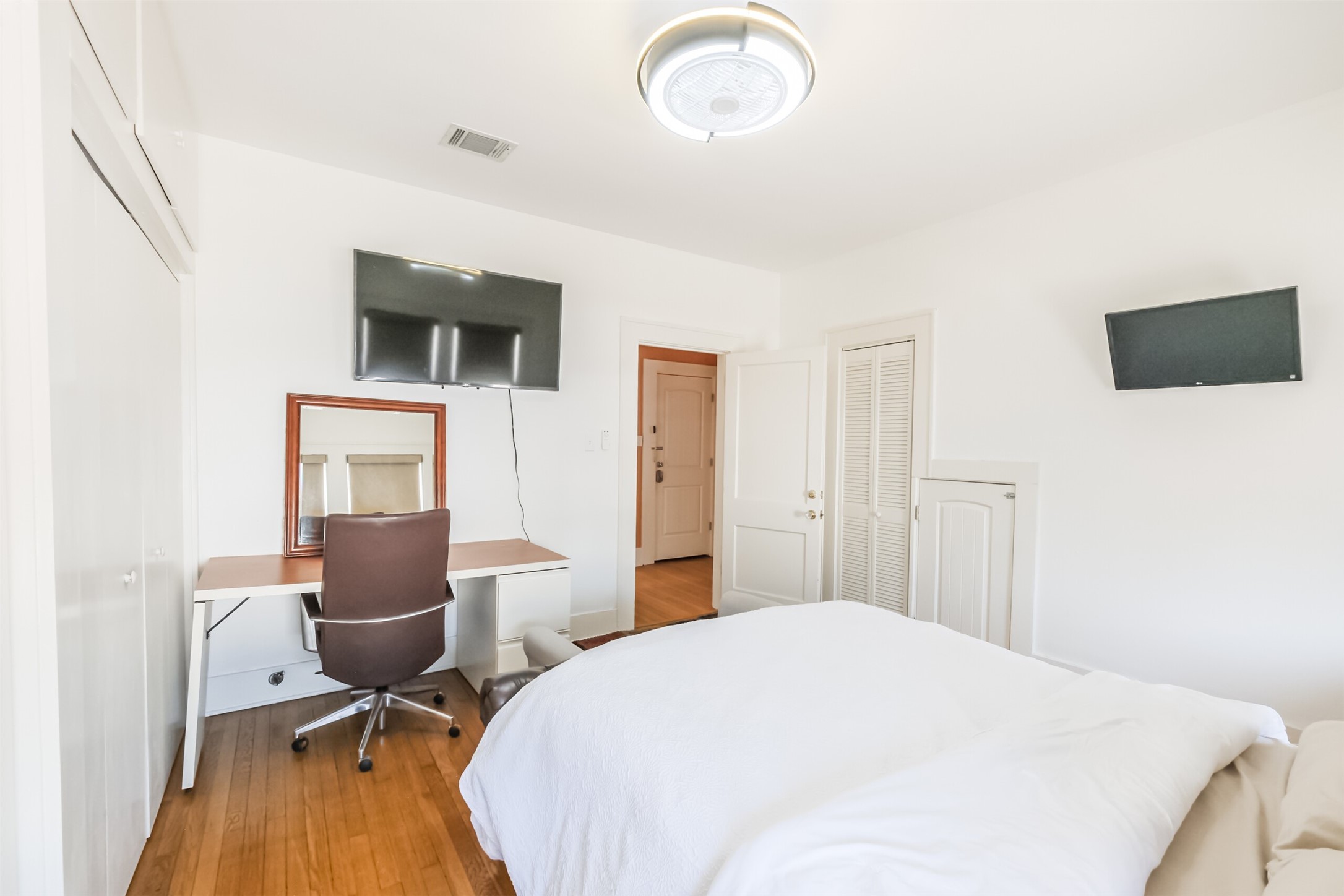 1716 Richmond Avenue, Unit 2 Houston, TX 77098 - Photo 13 of 21 a bedroom with a bed and wooden floor