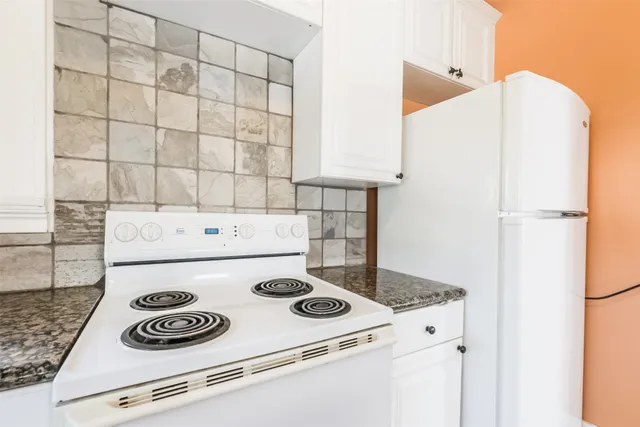 a kitchen with a stove and a refrigerator