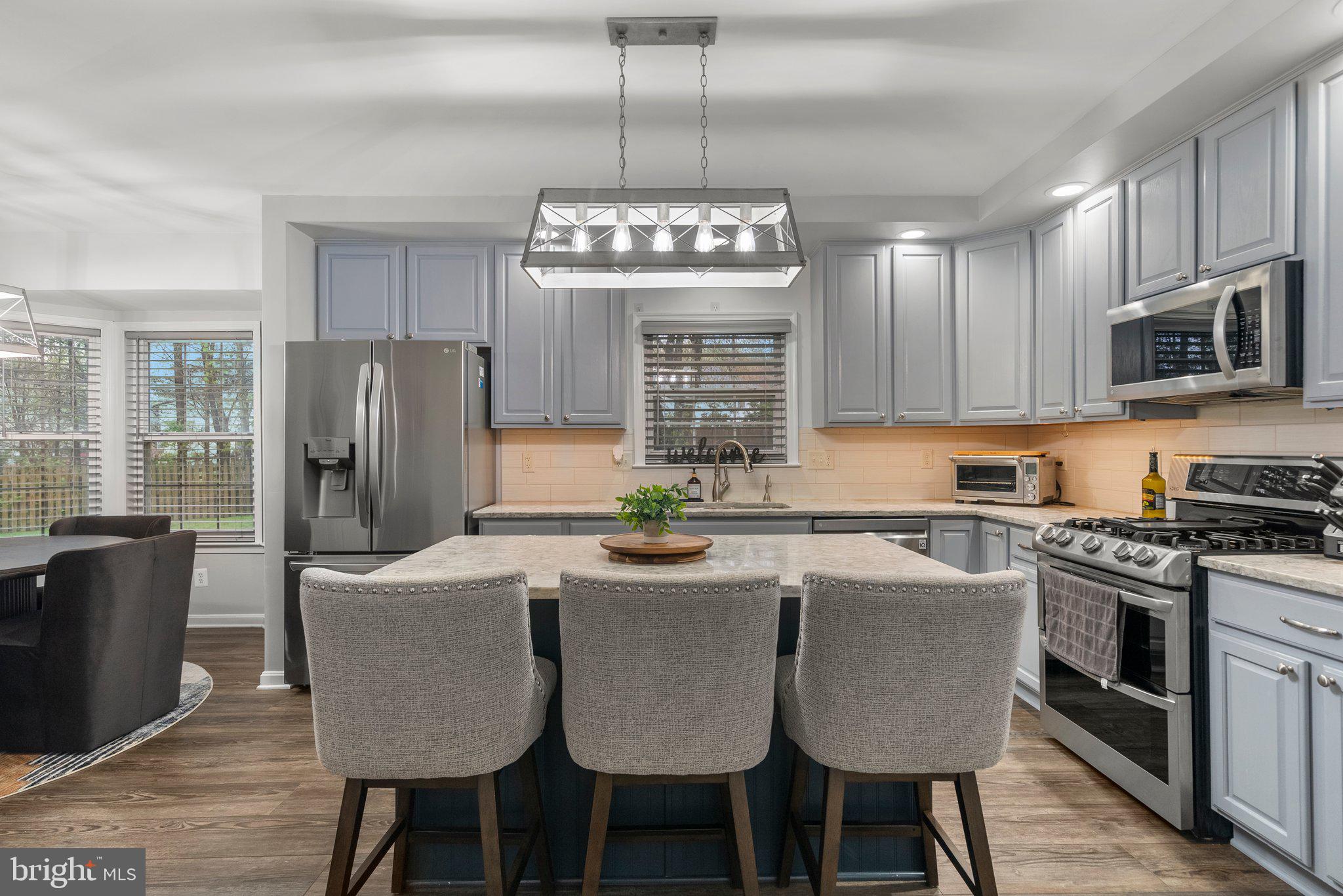 6355 Grant Chapman Drive La Plata, MD 20646 - Photo 14 of 57 a kitchen with refrigerator a stove a sink dishwasher a dining table and chairs