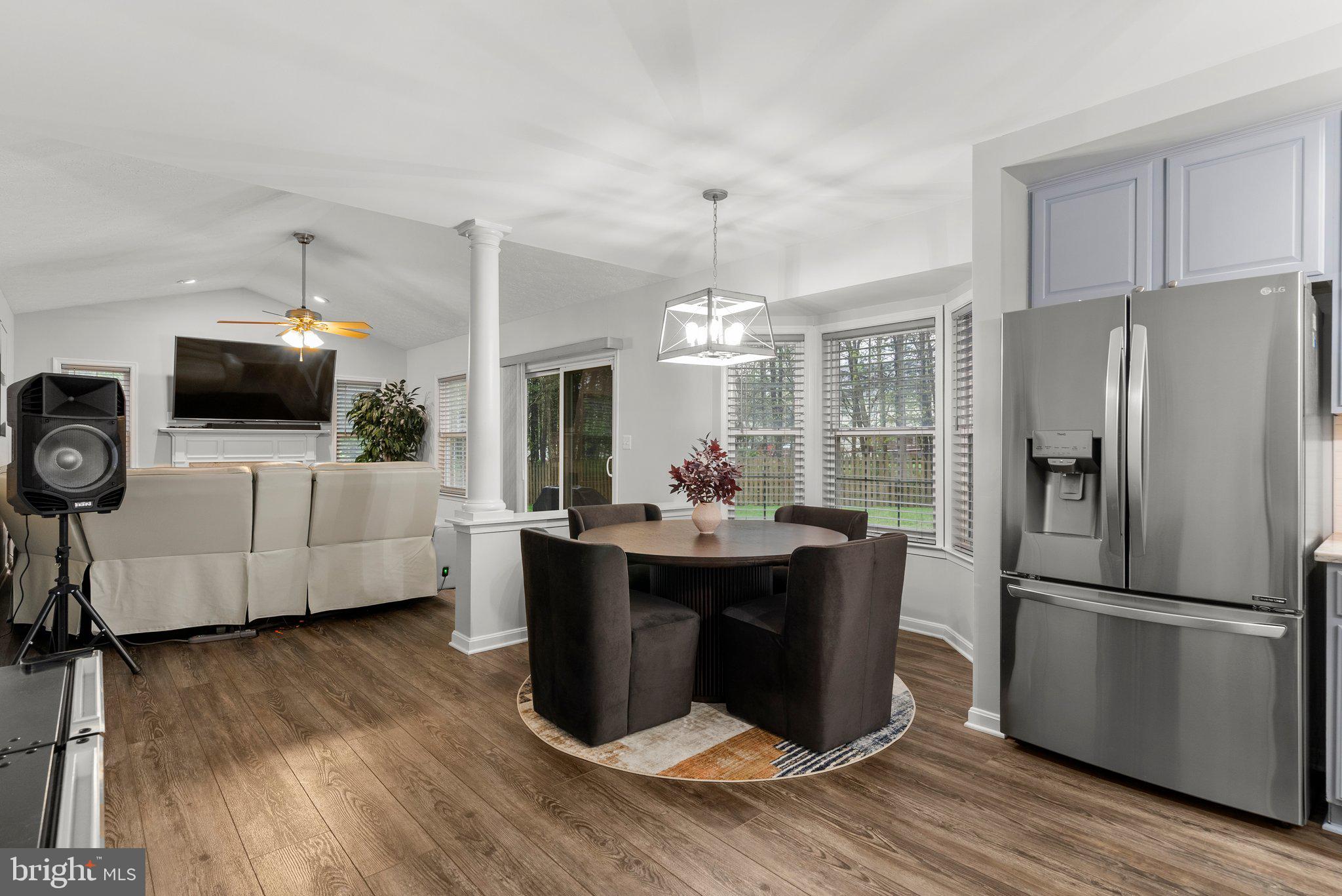 6355 Grant Chapman Drive La Plata, MD 20646 - Photo 19 of 57 a kitchen with stainless steel appliances a kitchen island hardwood floor and a view of living room