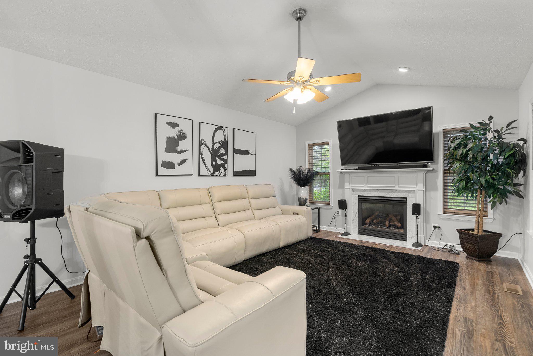 6355 Grant Chapman Drive La Plata, MD 20646 - Photo 24 of 57 a living room with furniture a fireplace and a flat screen tv