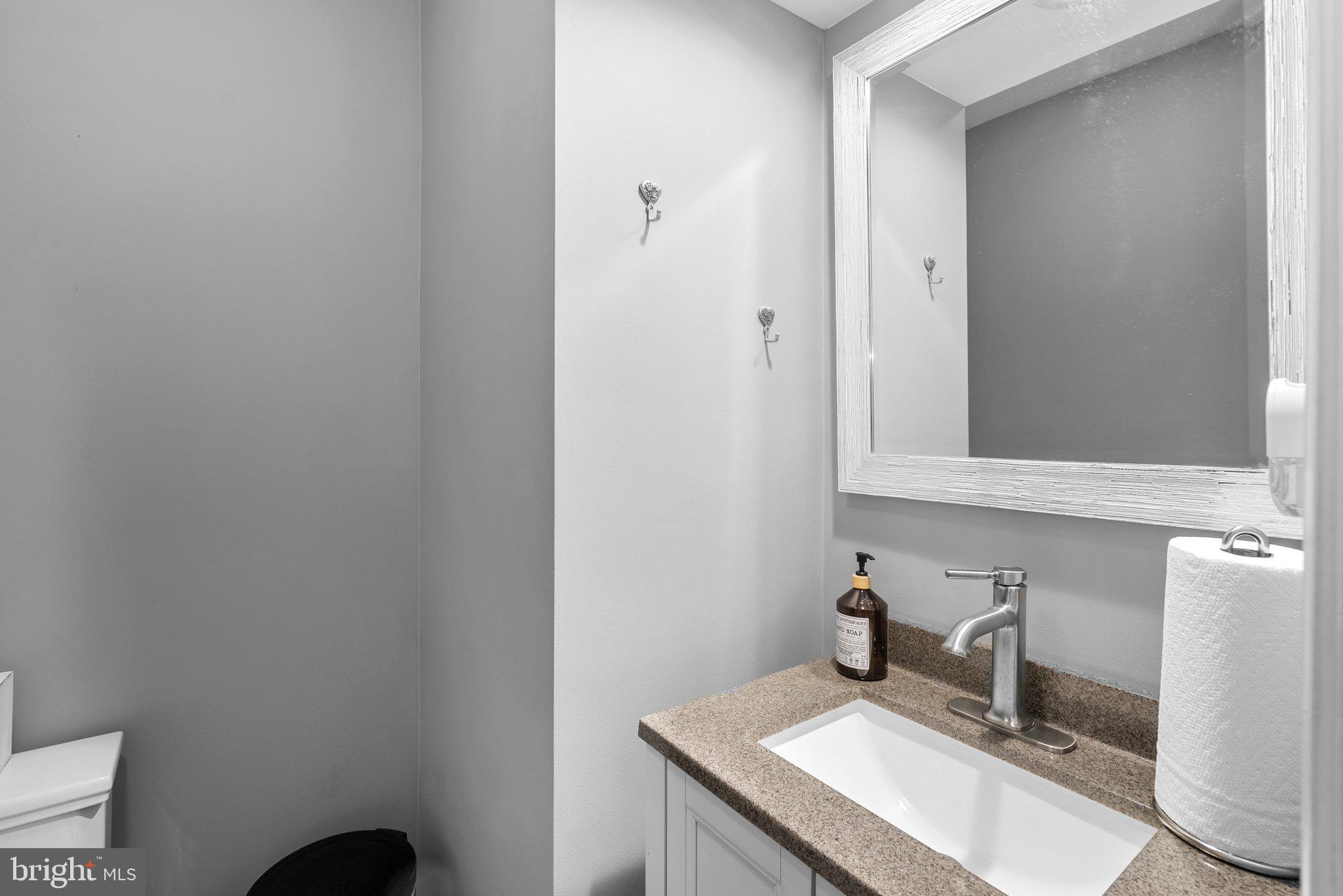 6355 Grant Chapman Drive La Plata, MD 20646 - Photo 27 of 57 a bathroom with a sink and a mirror