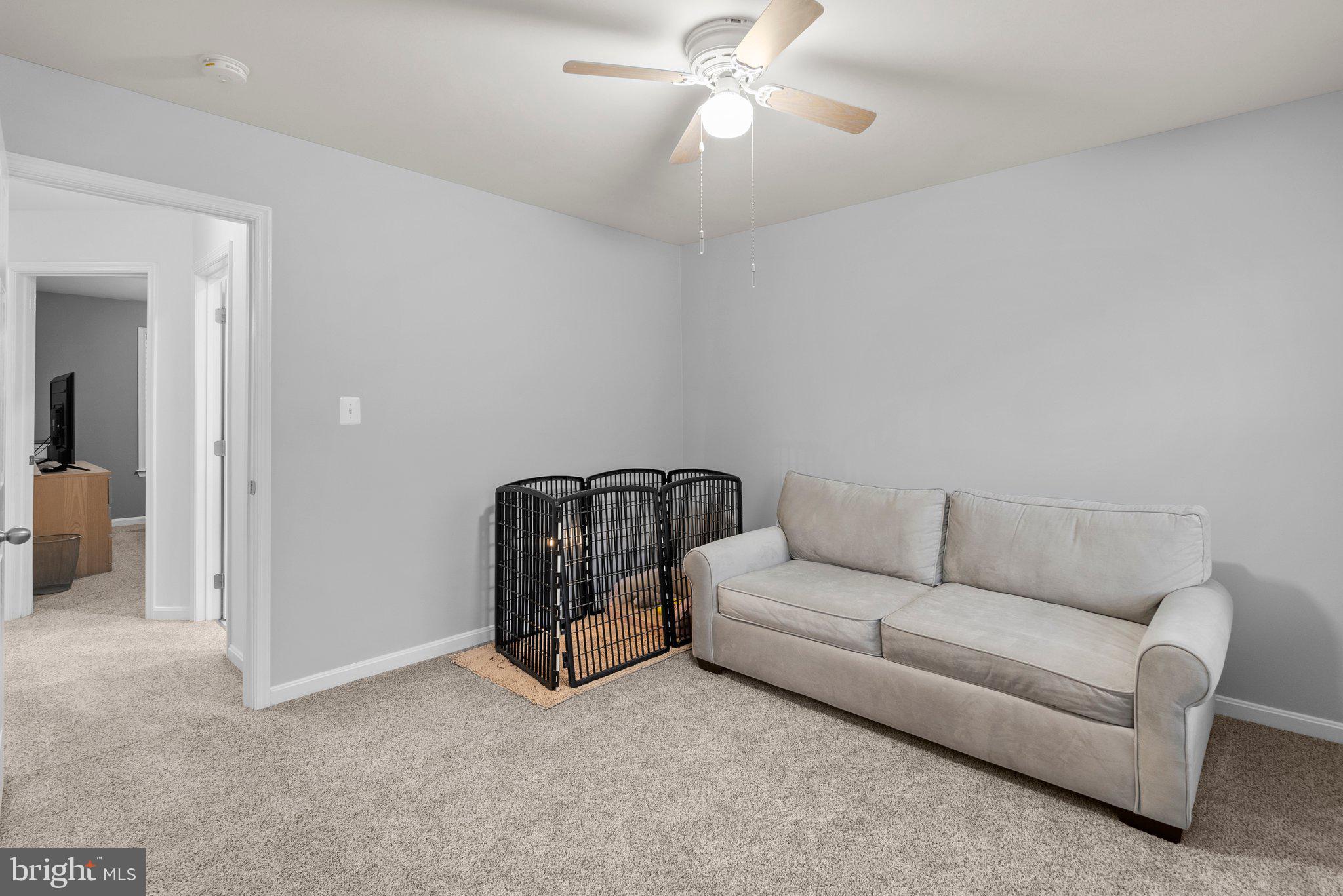 6355 Grant Chapman Drive La Plata, MD 20646 - Photo 36 of 57 a living room with furniture and a chandelier