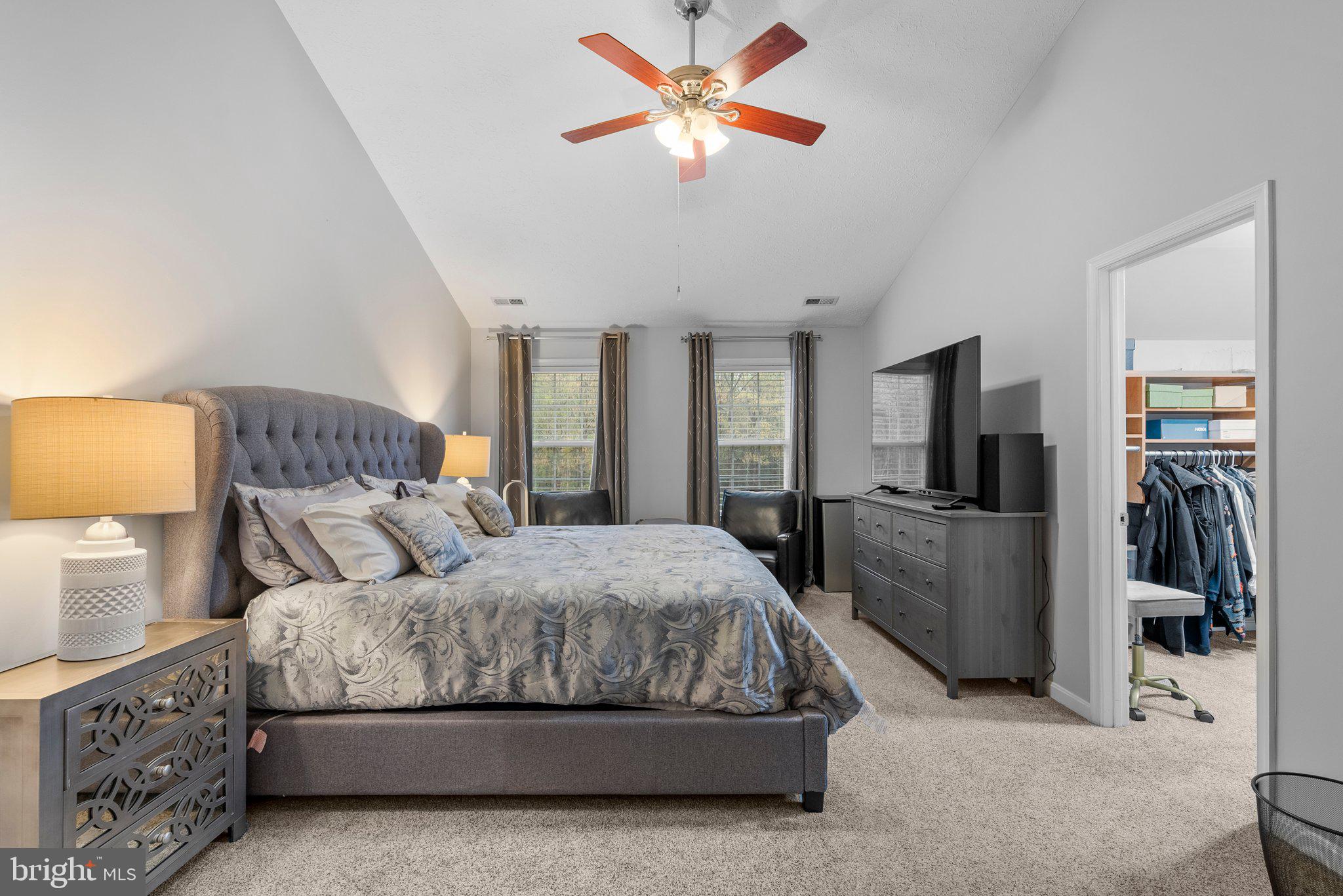 6355 Grant Chapman Drive La Plata, MD 20646 - Photo 41 of 57 a spacious bedroom with a bed and a chandelier