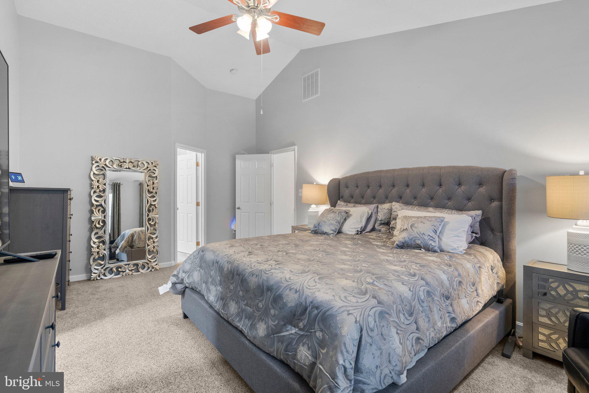 6355 Grant Chapman Drive La Plata, MD 20646 - Photo 42 of 57 a large bed sitting in a bedroom next to a chandelier