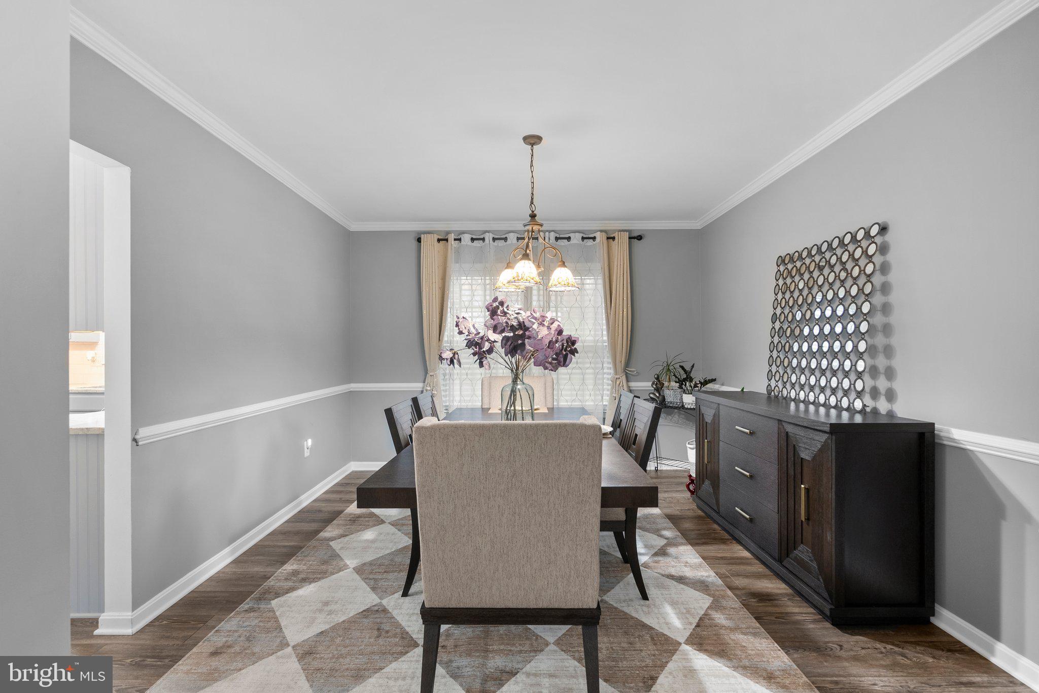 6355 Grant Chapman Drive La Plata, MD 20646 - Photo 10 of 57 a dining room with furniture a chandelier and window