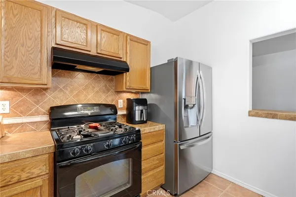 a kitchen with stainless steel appliances granite countertop a stove microwave and refrigerator