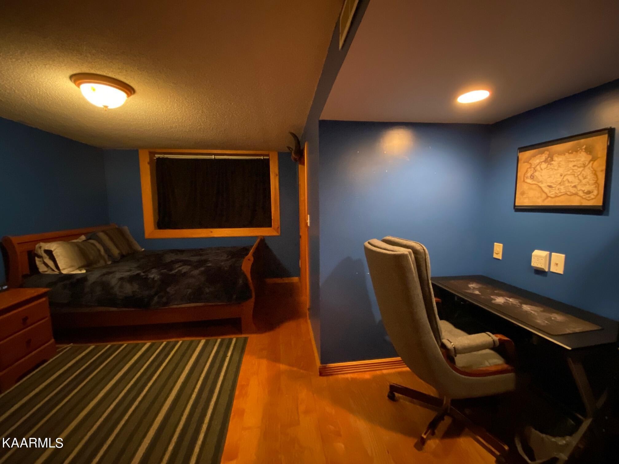 190 Dean Hill Road Oneida, TN 37841 - Photo 22 of 36 a living room with furniture a rug and a projector