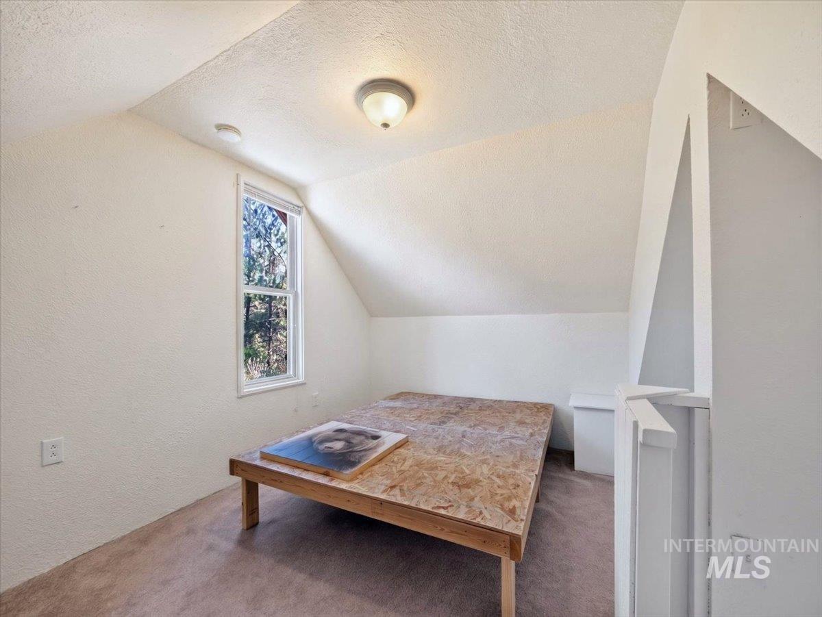 6 Rattlesnake Road Boise City, ID 83716 - Photo 38 of 50 Attic space featuring sloped ceilings, a double-hung window, and neutral-toned wall paint