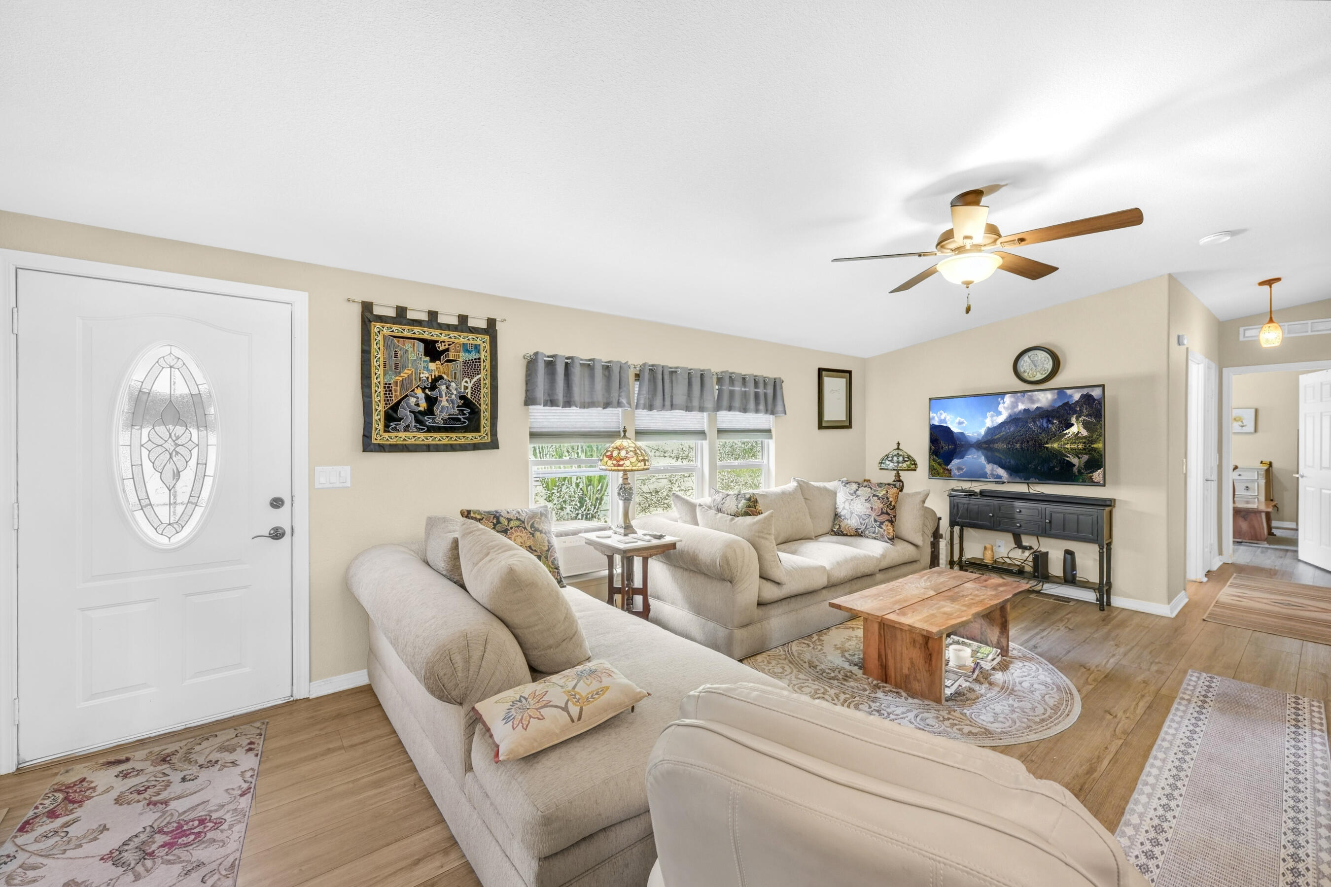 a living room with furniture a clock and a window