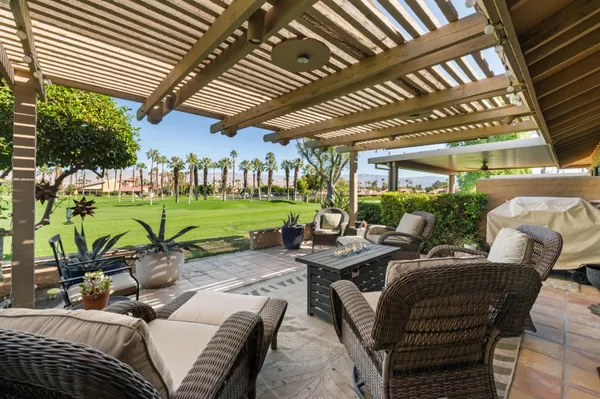 a view of a patio with table and chairs potted plants and a patio
