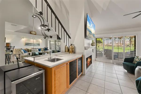 a kitchen with granite countertop a sink stainless steel appliances and cabinets