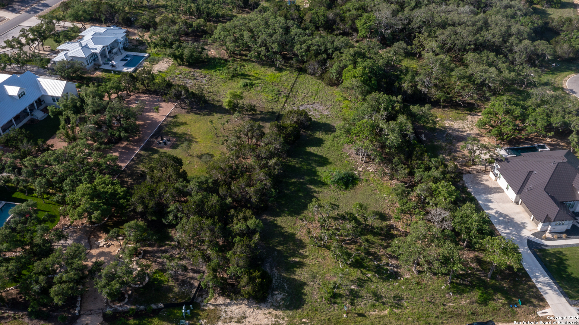 739 Maximino Ridge Road Bulverde, TX 78163 - Photo 5 of 36 an aerial view of residential house with outdoor space and trees all around