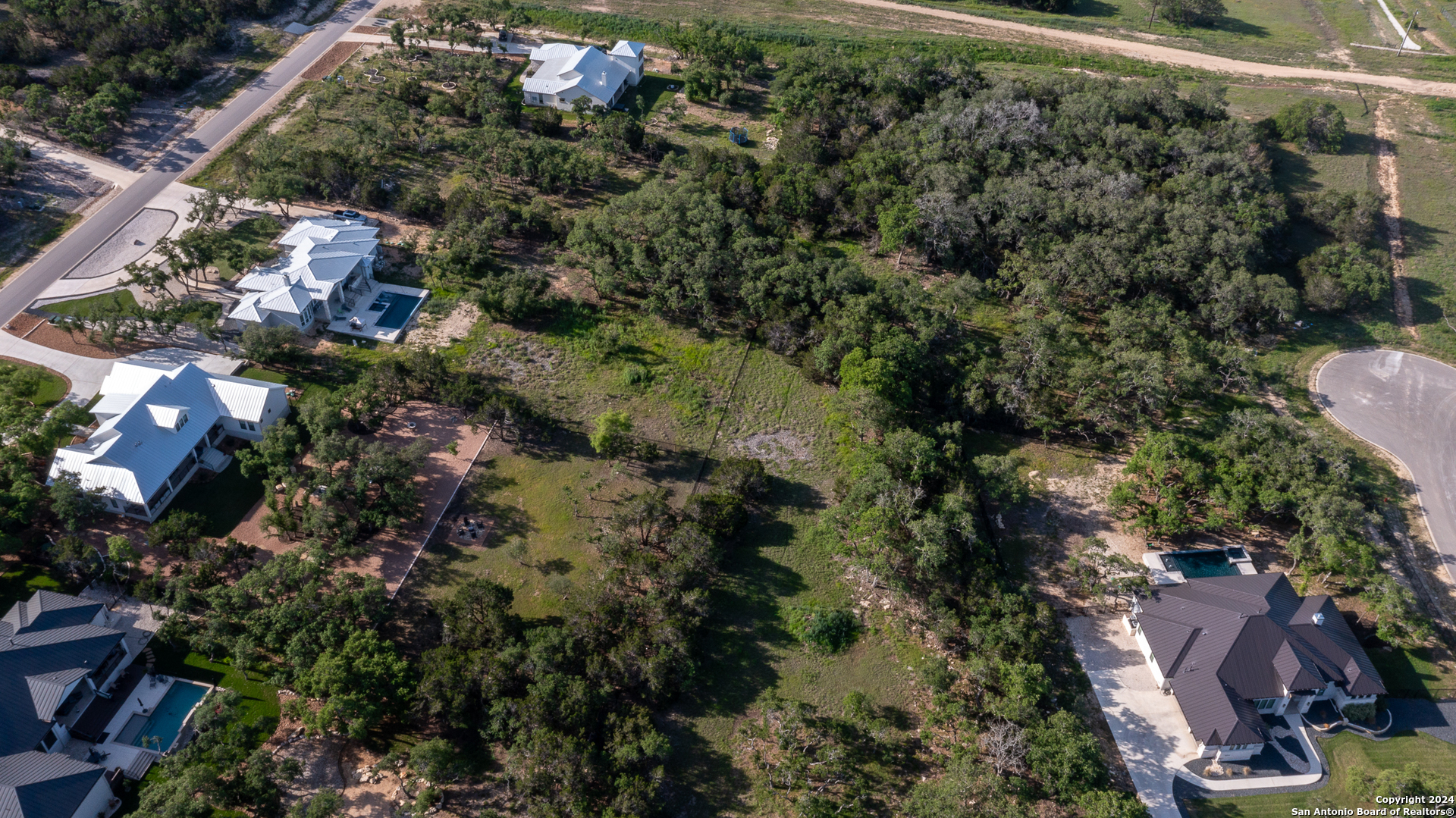 739 Maximino Ridge Road Bulverde, TX 78163 - Photo 6 of 36 an aerial view of residential house with outdoor space and trees all around