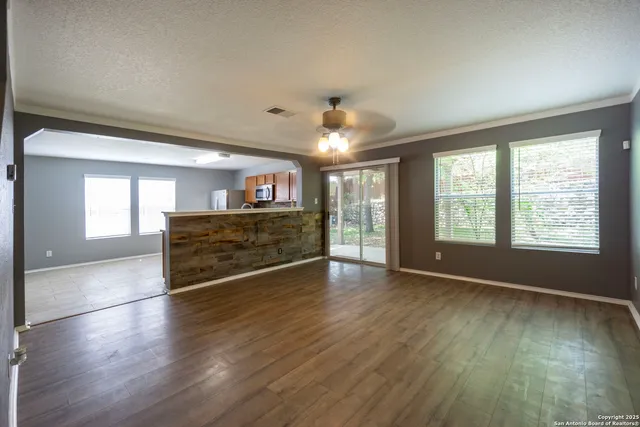 a view of a livingroom with furniture hardwood floor and hallway