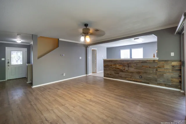 a view of a room with wooden floor and staircase