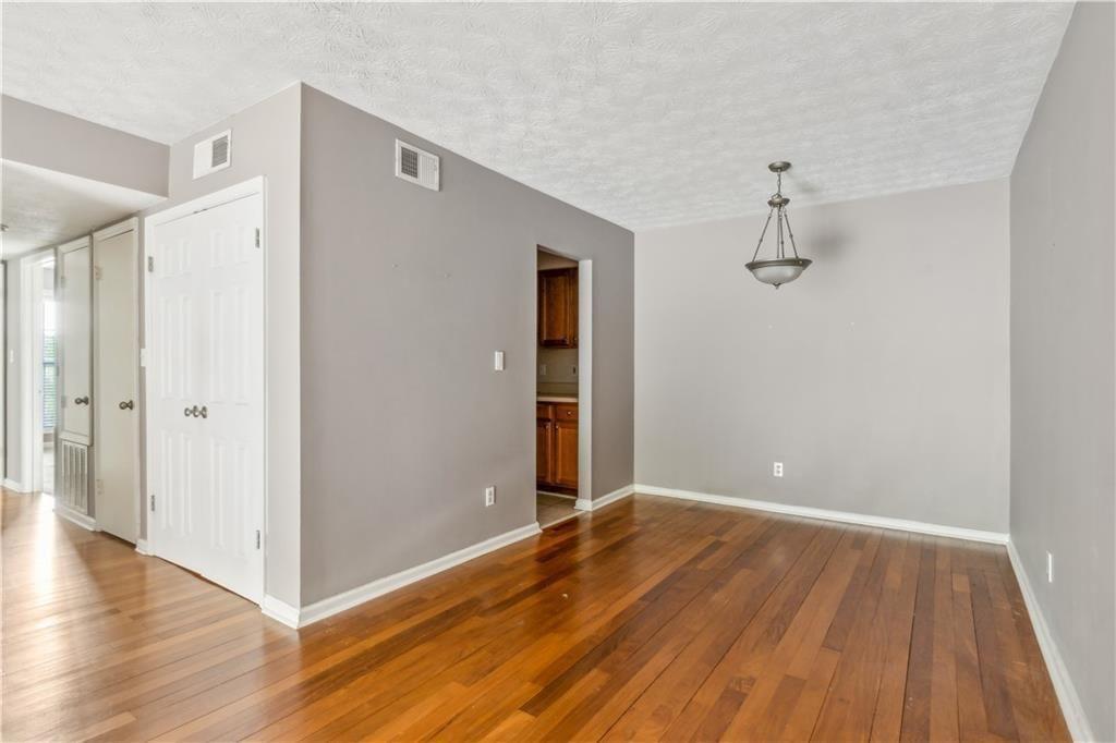 3155 Seven Pines, Unit 303 Atlanta, GA 30339 - Photo 7 of 25 a view of room with wooden floor