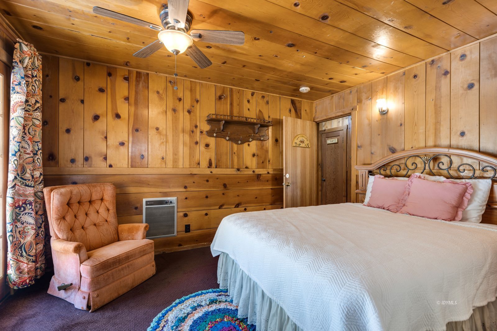 26770 Idyllwild Road Idyllwild, CA 92549 - Photo 17 of 56 a bedroom with a bed couch and a chandelier