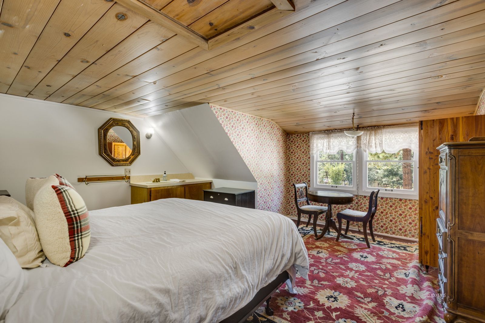 26770 Idyllwild Road Idyllwild, CA 92549 - Photo 28 of 56 a bed room with a bed and a table