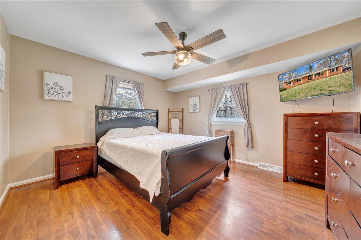414 Pin Oak Drive Blue Ridge, VA 24064 - Photo 16 of 45 a bed room with a bed and a ceiling fan