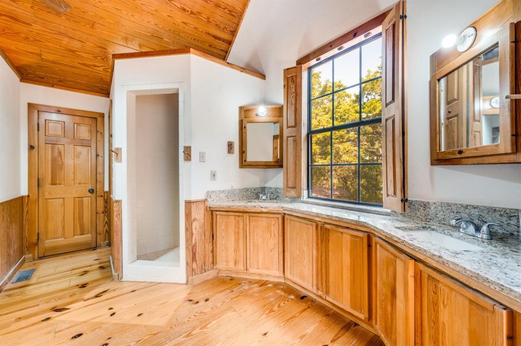 539 North Duncanville Road Cedar Hill, TX 75104 - Photo 21 of 36 a view of a kitchen with granite countertop wooden cabinets a granite counter top and a large window