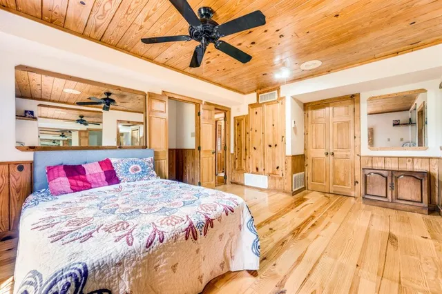 a bedroom with a large bed and a couch