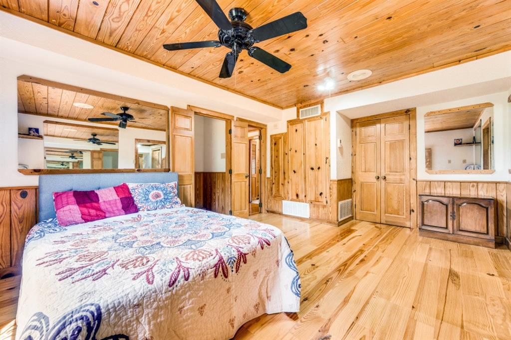 539 North Duncanville Road Cedar Hill, TX 75104 - Photo 23 of 36 a bedroom with a bed and a chandelier