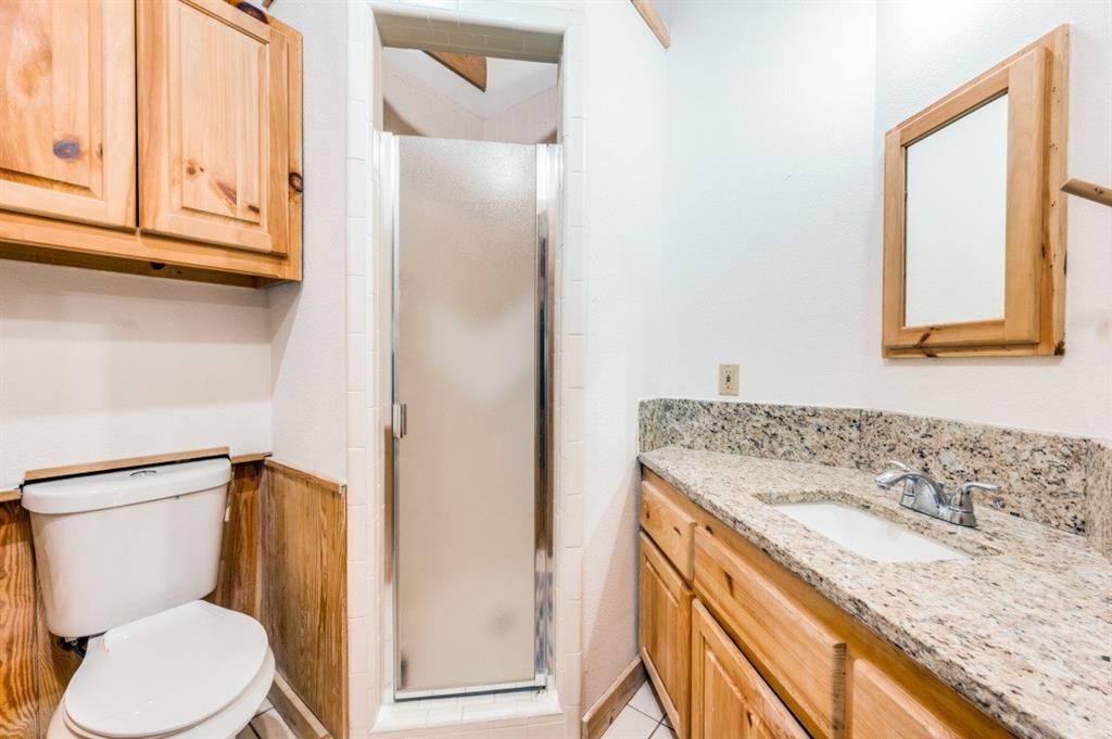 539 North Duncanville Road Cedar Hill, TX 75104 - Photo 24 of 36 a bathroom with a granite countertop sink toilet and shower