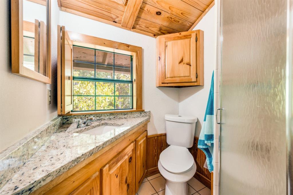 539 North Duncanville Road Cedar Hill, TX 75104 - Photo 28 of 36 a bathroom with a granite countertop toilet sink and mirror