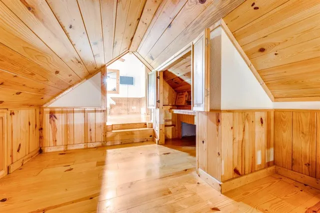 a view of a patio with wooden floor table and chairs