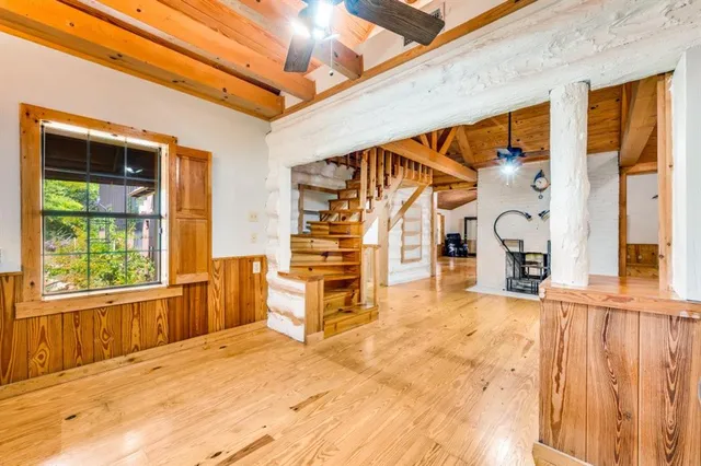 a view of a patio with table and chairs and a large window