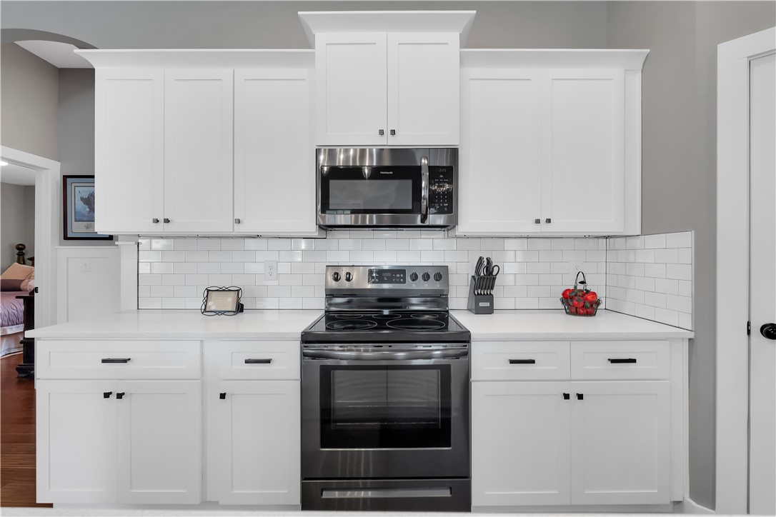 181 Amberwood Drive Anderson, SC 29621 - Photo 12 of 28 This modern kitchen features a sleek design with ample cabinetry and essential appliances.