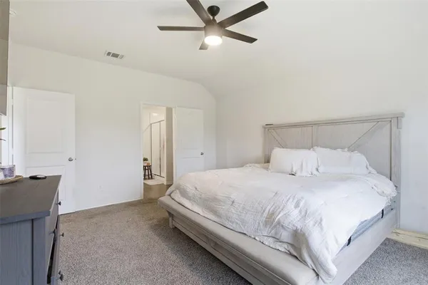 a bedroom with a bed and cabinet