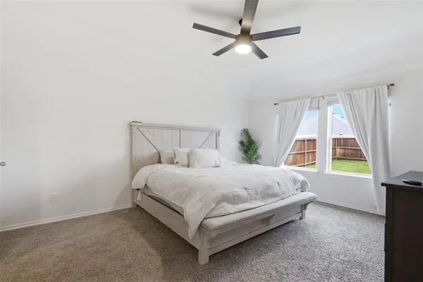 a bed sitting in a room next to a window