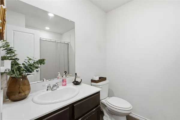 a bathroom with a sink toilet and mirror