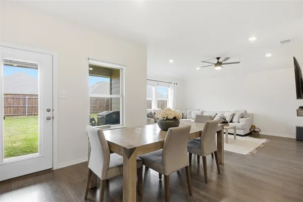 a view of a dining room with furniture and wooden floor
