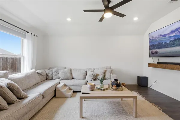 a living room with furniture and a flat screen tv