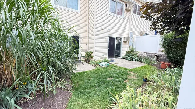 a front view of a house with yard and green space