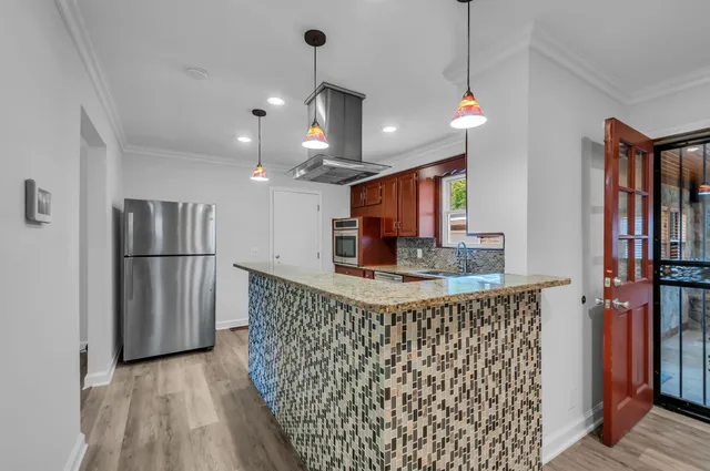 a view of a kitchen with a sink and refrigerator